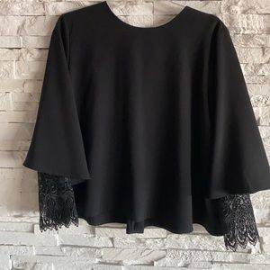 Go- ing long sleeved shirt with lace sleeve ends.